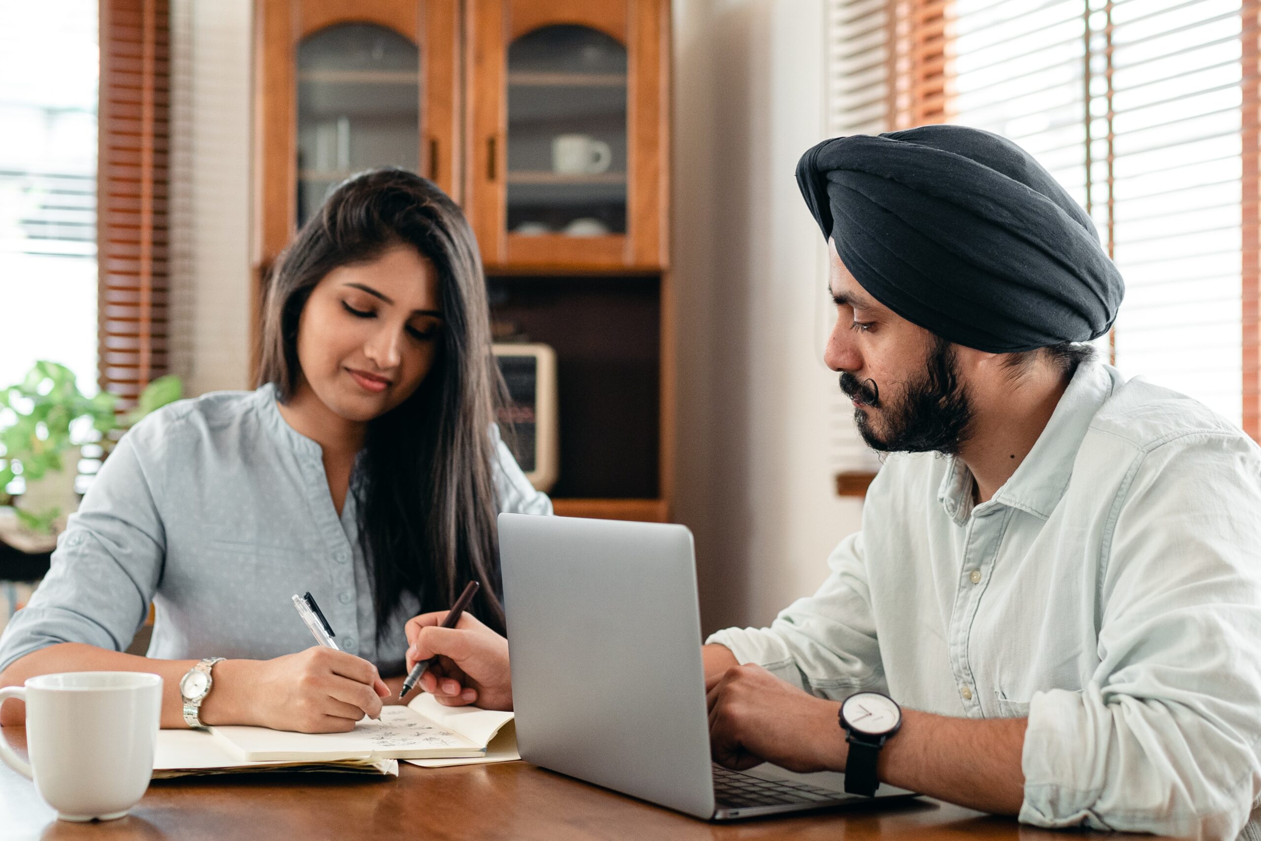 An Indian boy and girl working on their computer